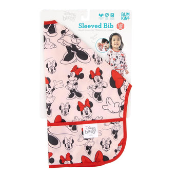 Bumkins Sleeved Bib: Minnie Mouse - pink, red-trimmed, with pocket. Ideal for weaning. Features waterproof design and child model on packaging.