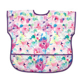 Bumkins Junior Bib: Watercolor features colorful floral patterns, purple trim, a front pocket, and waterproof fabric for easy cleaning.