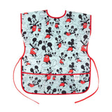 Bumkins Short-Sleeved Smock: Mickey Mouse Classic features a Mickey Mouse design on blue waterproof fabric, red trim, and adjustable closures.