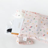 Bumkins Wet Bag: Princess Magic holds a notebook, soft toy, and brush on a white background.